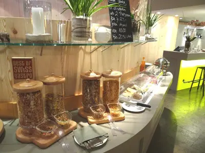 a table with three tall bottles of food on it at Herisau Swiss Quality Hotel in Herisau