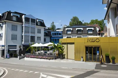 a yellow building on the side of a city street at Herisau Swiss Quality Hotel in Herisau