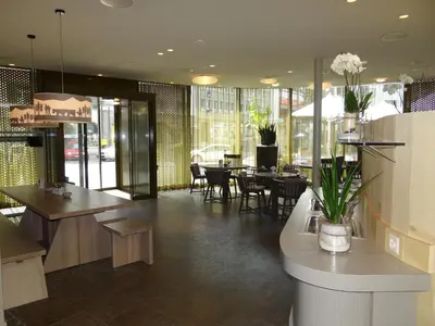 a restaurant with tables and chairs and a dining room at Herisau Swiss Quality Hotel in Herisau