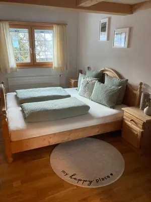 a bedroom with two beds and a happy place rug at Wies in Stein