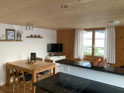a kitchen and dining room with a table and a television at Wies in Stein