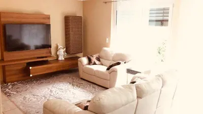 a living room with two couches and a flat screen tv at Alpen Panorama view Luxury House with green Garden in Buchs