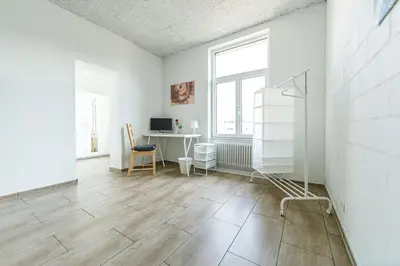 a room with a desk with a computer and a bunk bed at YELLOW INN - SIMPLE ROOMS -- OLMA Messen & Autobahn 1 Min, HSG 6 Min, Spital 7min, günstige Parkplätze in St. Gallen