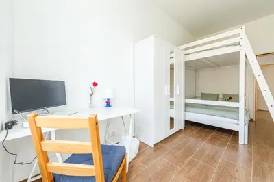 a dining room table with a vase of flowers on it at YELLOW INN - SIMPLE ROOMS -- OLMA Messen & Autobahn 1 Min, HSG 6 Min, Spital 7min, günstige Parkplätze in St. Gallen