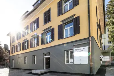 a bedroom with a bunk bed with a ladder at YELLOW INN - SIMPLE ROOMS -- OLMA Messen & Autobahn 1 Min, HSG 6 Min, Spital 7min, günstige Parkplätze in St. Gallen