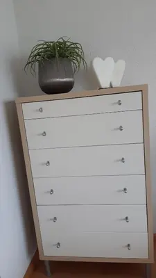 a dresser with a plant on top of it at Attika Ferienwohnung Merk in Kreuzlingen