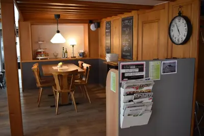 a kitchen and dining room with a table and a refrigerator at Gasthaus Sternen in Degersheim