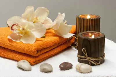 a couple of candles and towels with flowers on them at Giesserei in Arbon