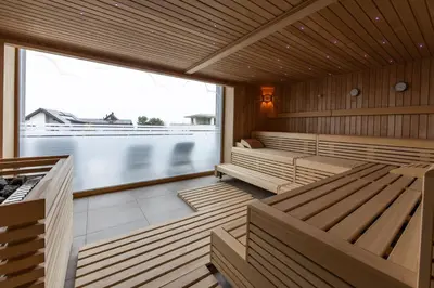 a sauna with wooden benches and a large window at Historische Residenz Lindeneck in Güttingen