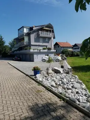 a house with a car parked in front of it at Studio direkt am Bodensee in Thal
