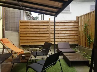 a patio with chairs and a wooden fence at 3 Doppel Zimmer Apartement in 9320 Arbon in Arbon