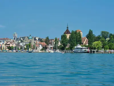 a large body of water with a city and boats at 3 Doppel Zimmer Apartement in 9320 Arbon in Arbon