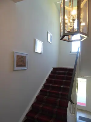 a stairway with a chandelier and a stair case at VILLA TAEGERMOOS in Tägerwilen