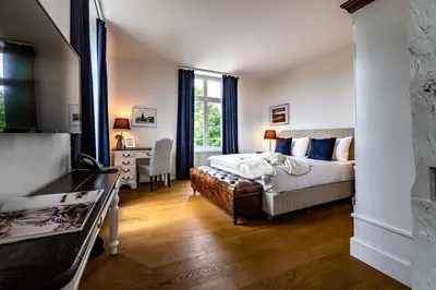 a bedroom with a bed and a desk in a room at VILLA TAEGERMOOS in Tägerwilen