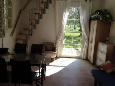 a bedroom with two beds and a tv in a attic at 2-Zimmer-Ferienhäuschen am Bodensee in Güttingen