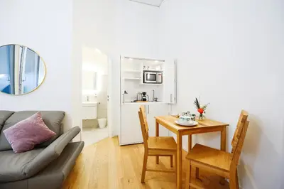 a living room with a table and a couch at Hotel Profis in Diepoldsau