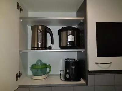 a shelf with two coffee makers and a tea pot at 3 Doppelbett Business Apartment am Bodensee in Arbon