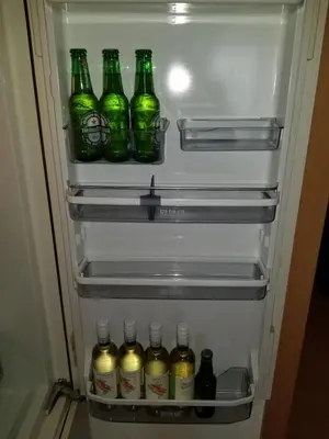 a refrigerator filled with lots of bottles of beer at 3 Doppelbett Business Apartment am Bodensee in Arbon
