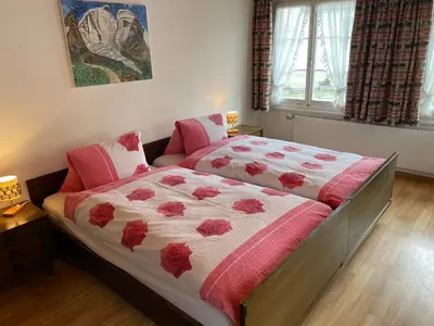 a bedroom with two beds with red flowers on it at Landgasthof Schäfle in Sankt Peterzell