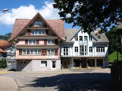 a large house on the corner of a street at Zwinglis Ferienwohnung in Nesslau