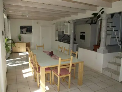 a kitchen and dining room with a table and chairs at Zwinglis Ferienwohnung in Nesslau