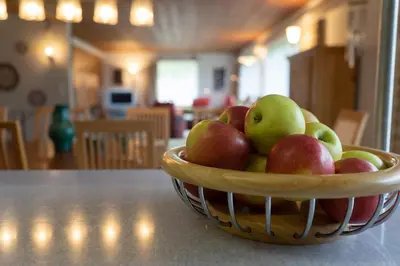 a basket of apples sitting on a table at Jambo Pua in Alt Sankt Johann