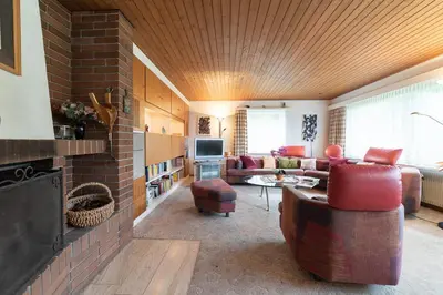 a living room with a couch and a fireplace at Jambo Pua in Alt Sankt Johann