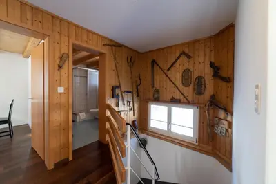 a hallway with wood paneling and a window at Sonnhalde in Wildhaus
