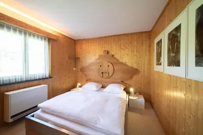 a bedroom with a bed with a wooden wall at Frühweid in Unterwasser
