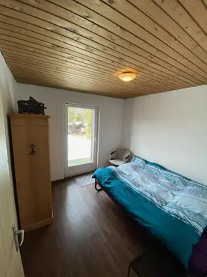 a bedroom with a bed and a wooden ceiling at Säntisecho - in der Natur zu Hause in Urnäsch