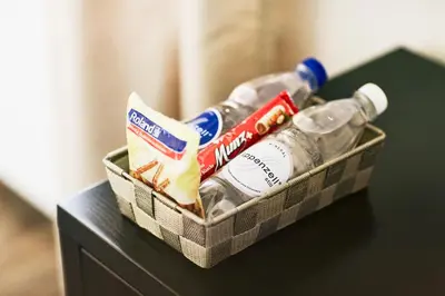 a basket of toothpaste and drinks on a table at Hotel Schäfli in Uzwil
