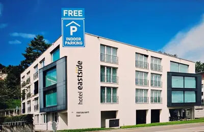 a building with a free parking sign in front of it at Hotel Eastside (free parking garage) in St. Gallen