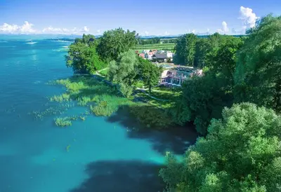 an aerial view of a river with trees and a house at Hotel Restaurant Sokrates in Güttingen