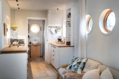 a living room with a couch and a kitchen at Logis Freyja in Landschlacht Gemeinde Münsterlingen