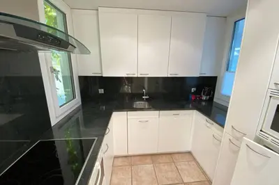 a kitchen with white cabinets and a sink at Exklusive Mini-Villa mit viel Platz in Herisau