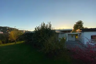 a small white house with a yard at Exklusive Mini-Villa mit viel Platz in Herisau