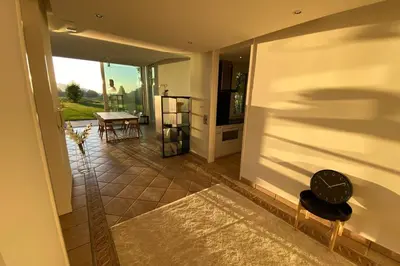 a hallway with a room with a table and a mirror at Exklusive Mini-Villa mit viel Platz in Herisau