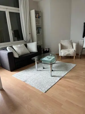 a living room with a glass table and a couch at over-night City-Flat in St. Gallen