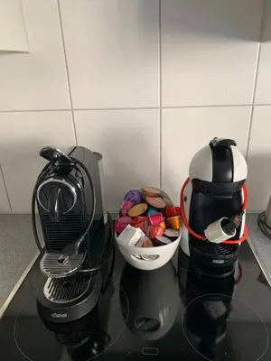 two coffee cups sitting on top of a counter at over-night City-Flat in St. Gallen