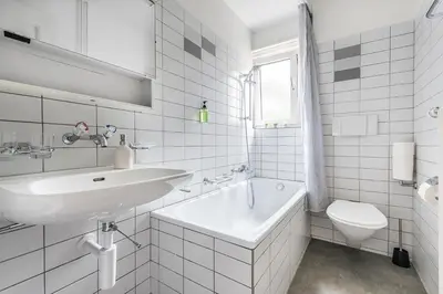 a white bathroom with a sink and a toilet at SOHO 11 !Gratis Parken, Free Parking! in Kreuzlingen