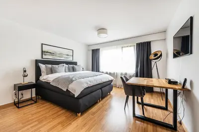 a bedroom with a bed and a desk and a desk at SOHO 11 !Gratis Parken, Free Parking! in Kreuzlingen