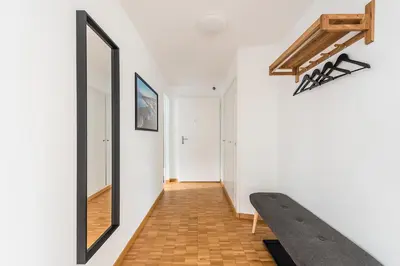 a hallway with a mirror and a bench on the wall at SOHO 11 !Gratis Parken, Free Parking! in Kreuzlingen