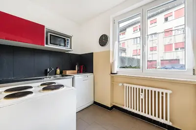 a kitchen with a white stove top oven next to a window at SOHO G !Gratis Parken, Free Parking! in Kreuzlingen