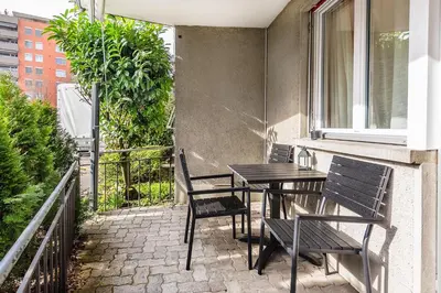 a patio with a table and chairs on a balcony at SOHO G !Gratis Parken, Free Parking! in Kreuzlingen