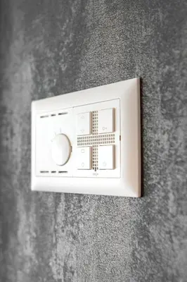 a white light switch on a gray wall at Wohntel - wohnen wie im Hotel in Sevelen