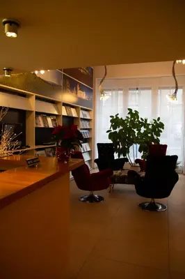 a living room with a counter and chairs and a table at Boutique City Hotel Gallo in St. Gallen