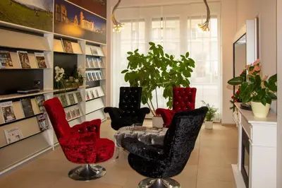 a living room with four chairs and a table at Boutique City Hotel Gallo in St. Gallen