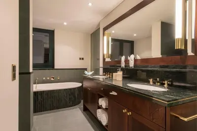 a bathroom with two sinks and a bath tub at Bad Horn - Hotel & Spa in Horn