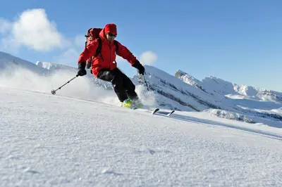 a man is skiing down a snow covered slope at Hotel Säntis Lodge in Unterwasser