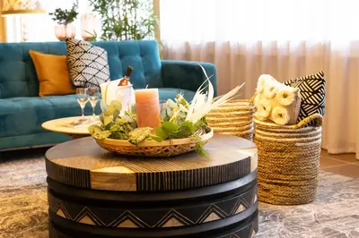 a living room with a table with a candle and a couch at Hotel Säntis Lodge in Unterwasser